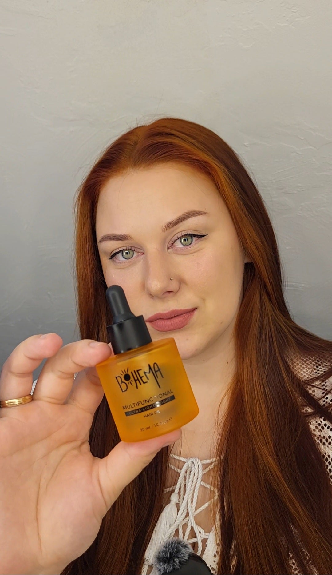 Picture of happy customer, holding BOHEMA HAIR Oil bottle